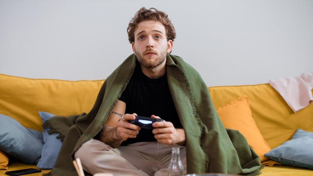 30-year-old man playing video games at home