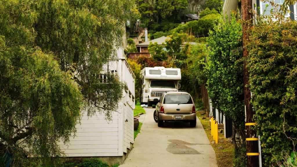 Camper parked in driveway of house