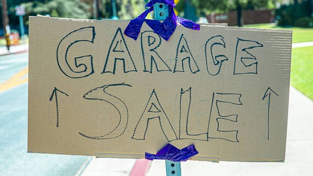 Homemade garage sale sign attached to a road sign