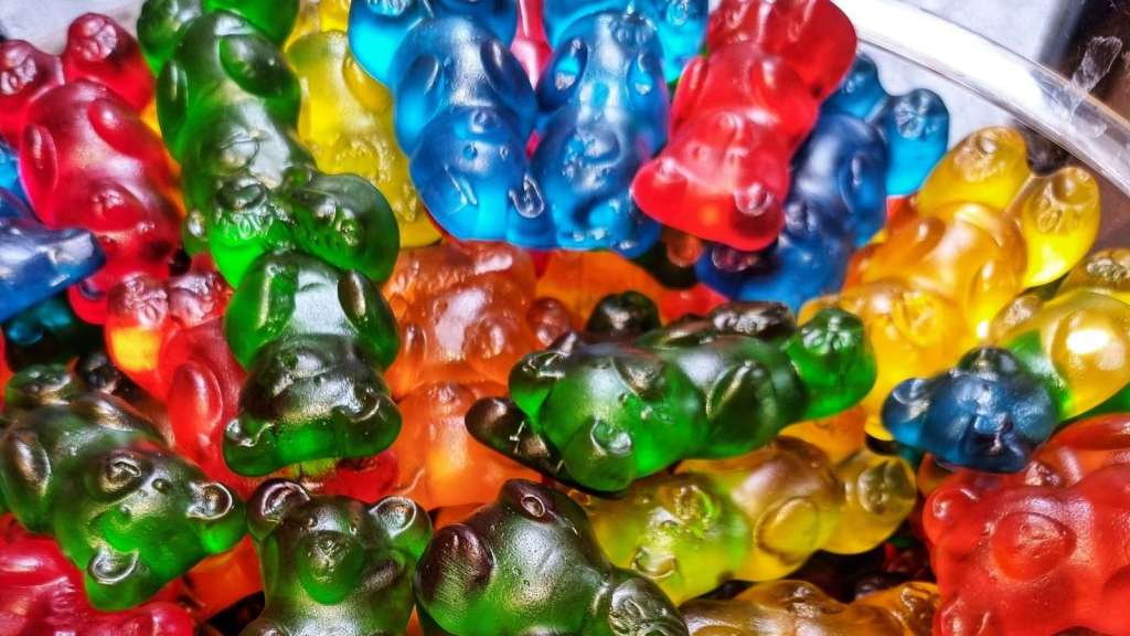 All colors of gummy bears in a jar