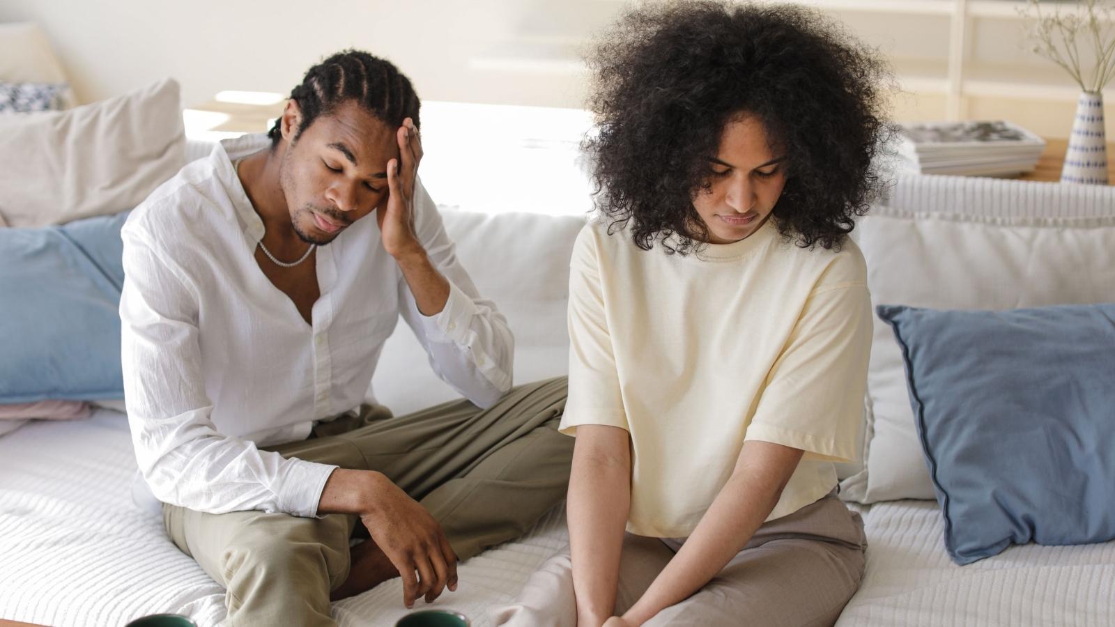 Their Neighbor’s Home Became a Serious Safety Concern—So Why Haven’t Authorities Done Anything? Couple sitting on their couch, stressed about neighbors