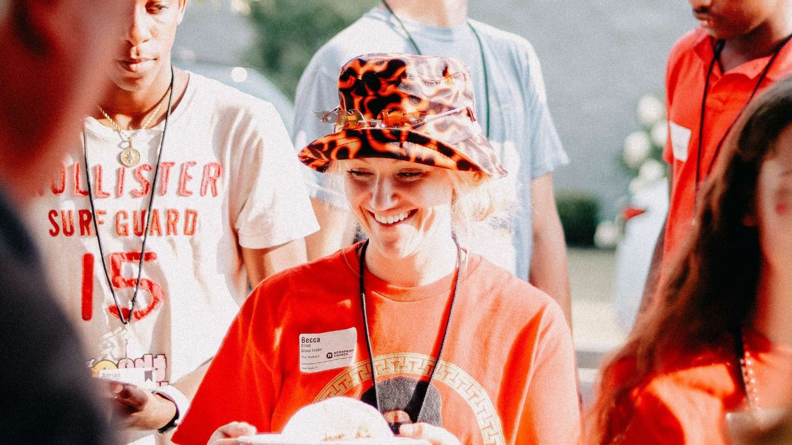 Woman wearing a red bucket hat at summer camp
