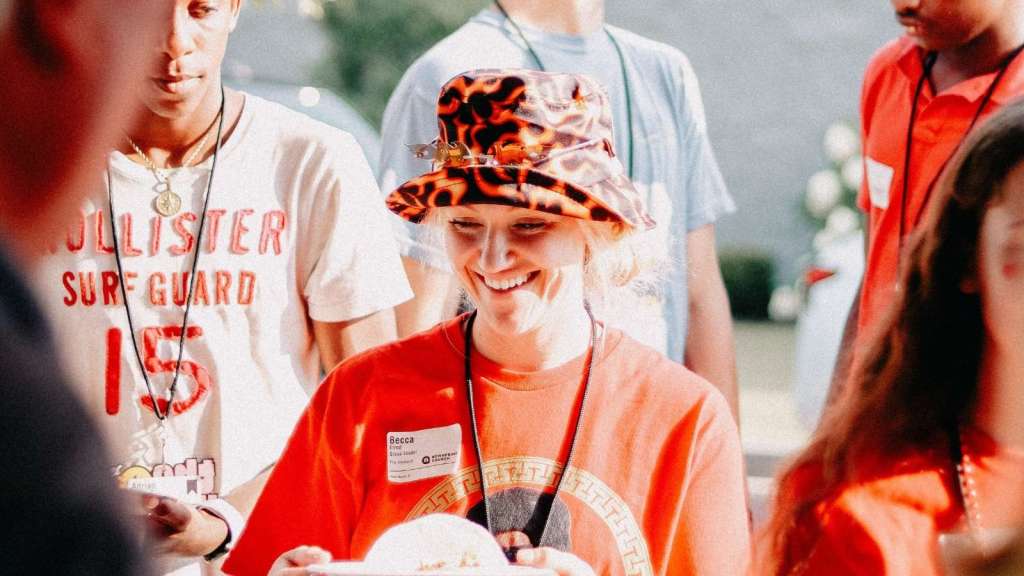 Woman wearing a red bucket hat at summer camp