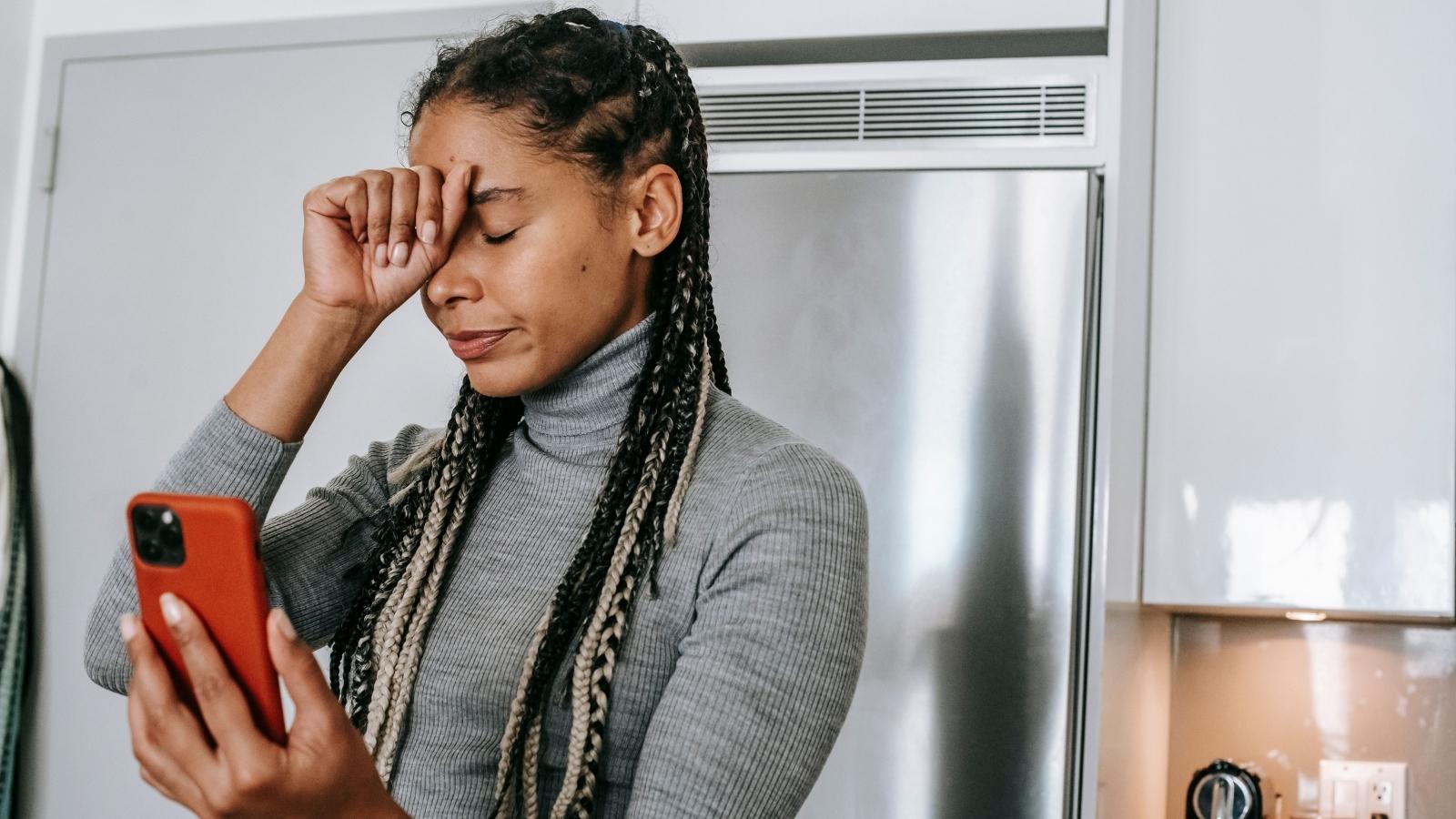 Woman holding her head because she set boundaries with BFF