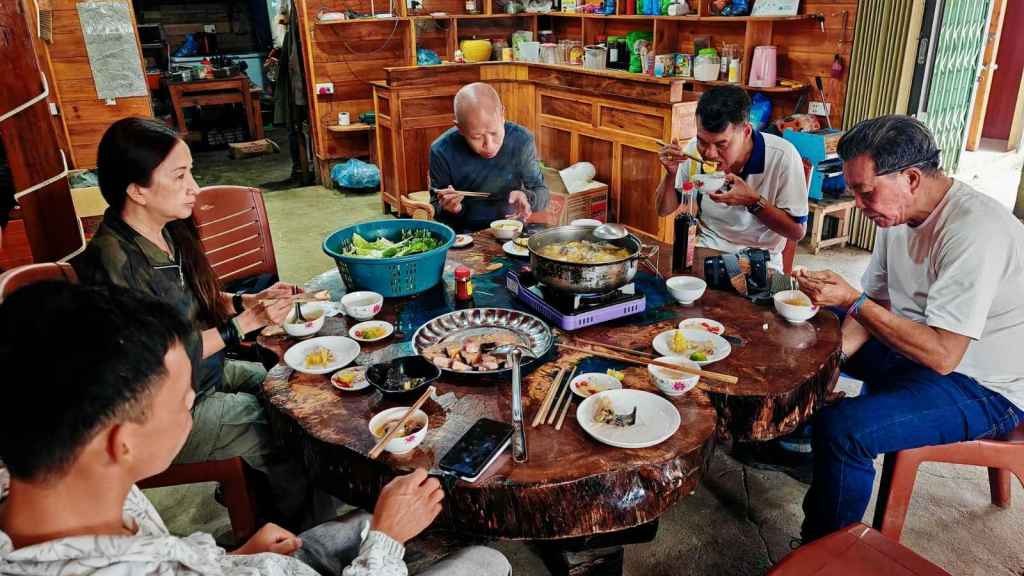 Asian family sitting around a dinner table