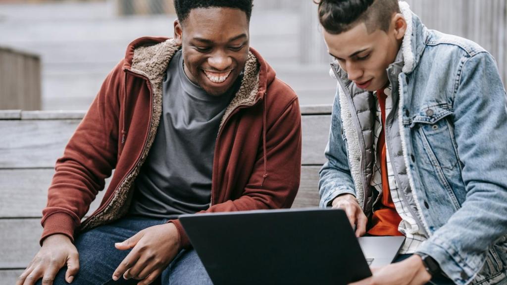 Guy showing his friend a website