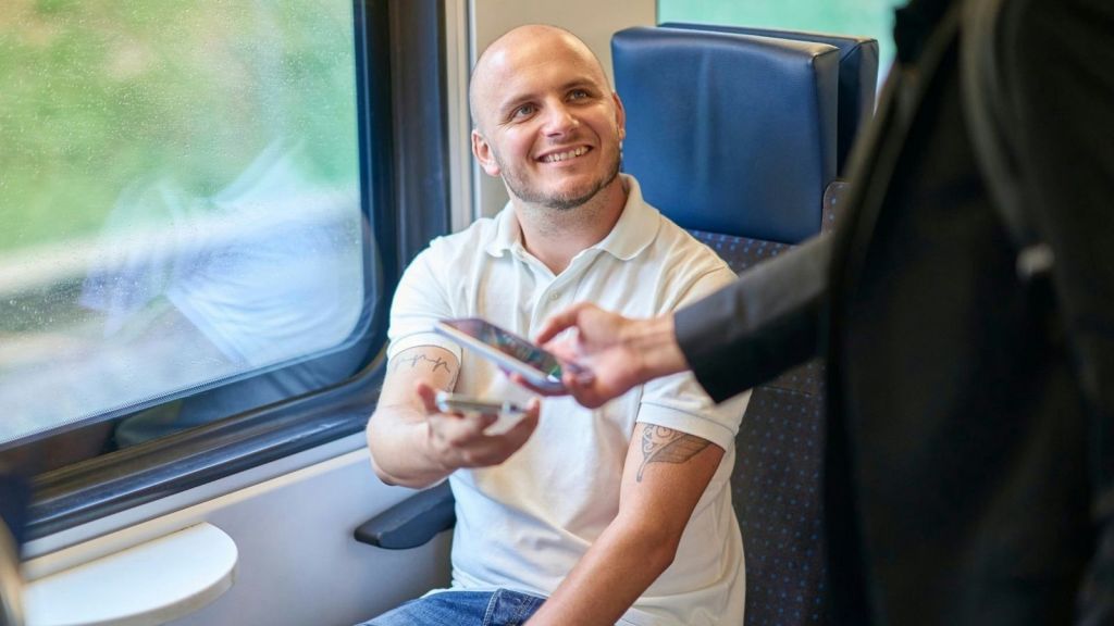 Man showing his boarding pass on a train