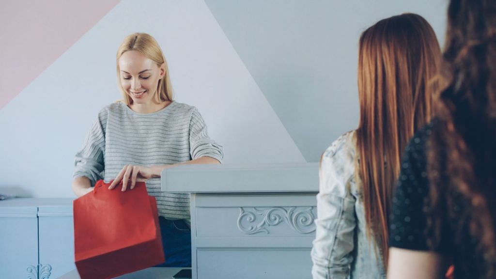 Cashier bagging up a customer's purchases