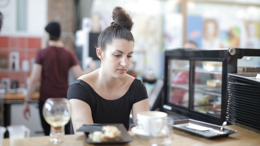 Server sitting at table processing her thoughts