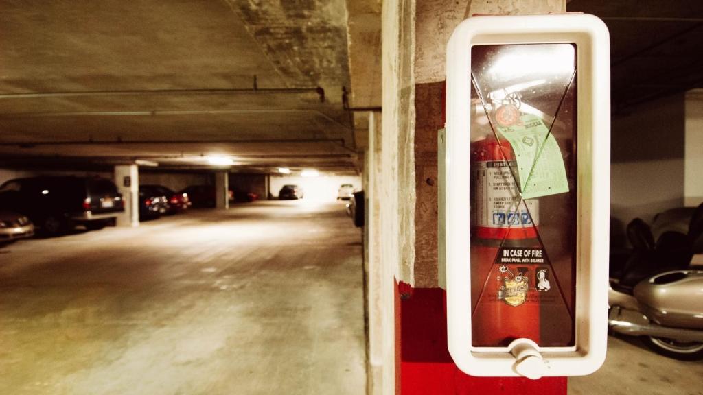 Fire extinguisher hanging in a parking garage