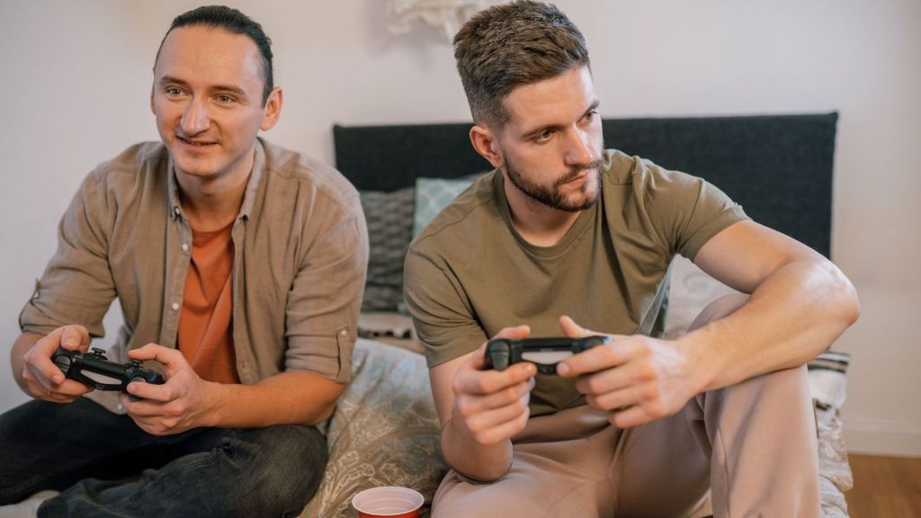 Two friends playing video games together