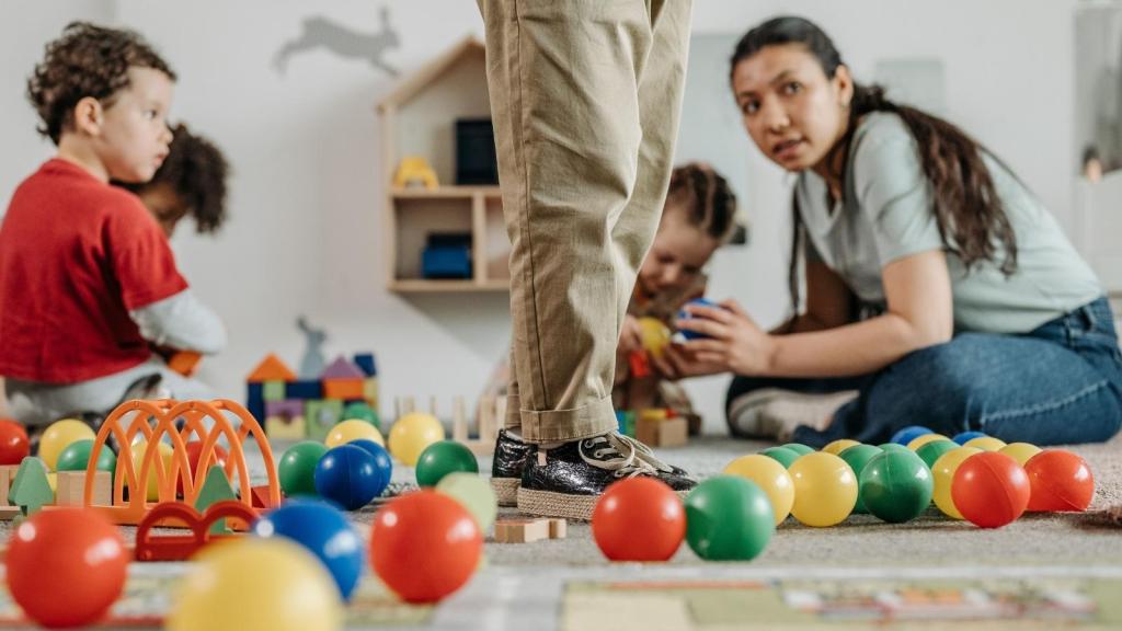 Daycare teacher interacting with children