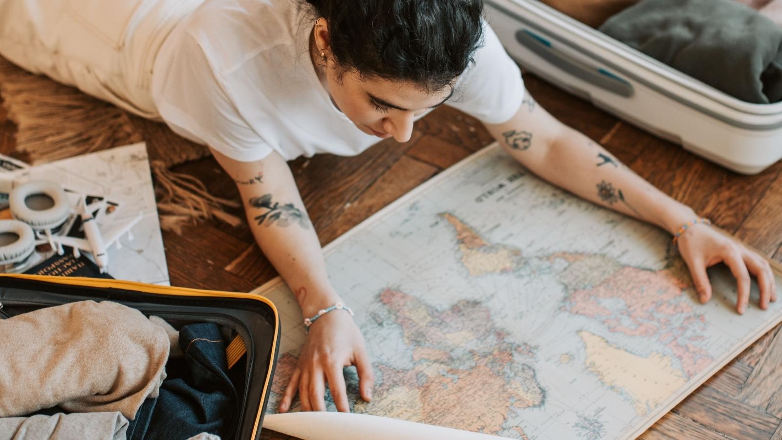 woman planning travel looking at map