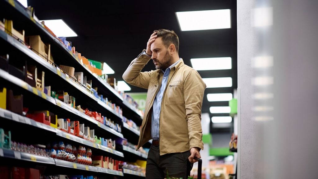 worried man in a grocery store