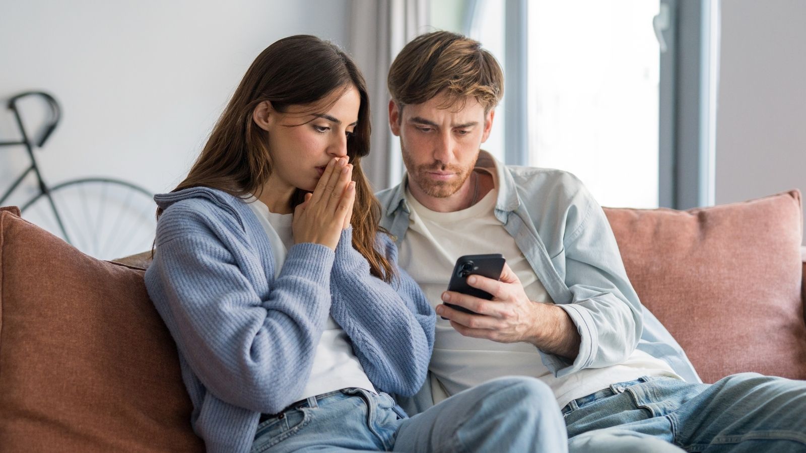 worried couple looking at a phone