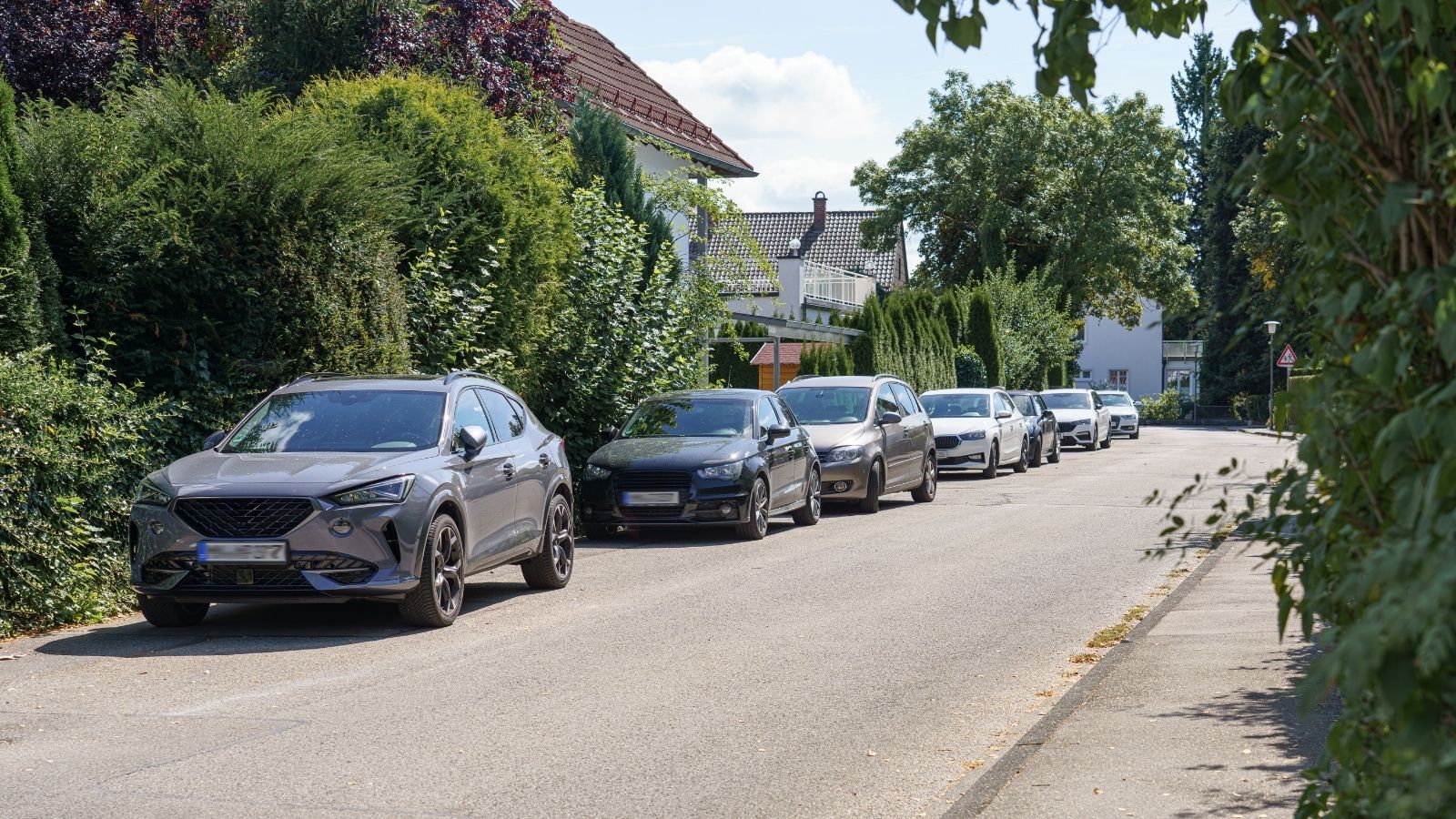 His Neighbors Get Upset When He Parks in Front of Their House — He Parks There Anyway cars parked on a residential street