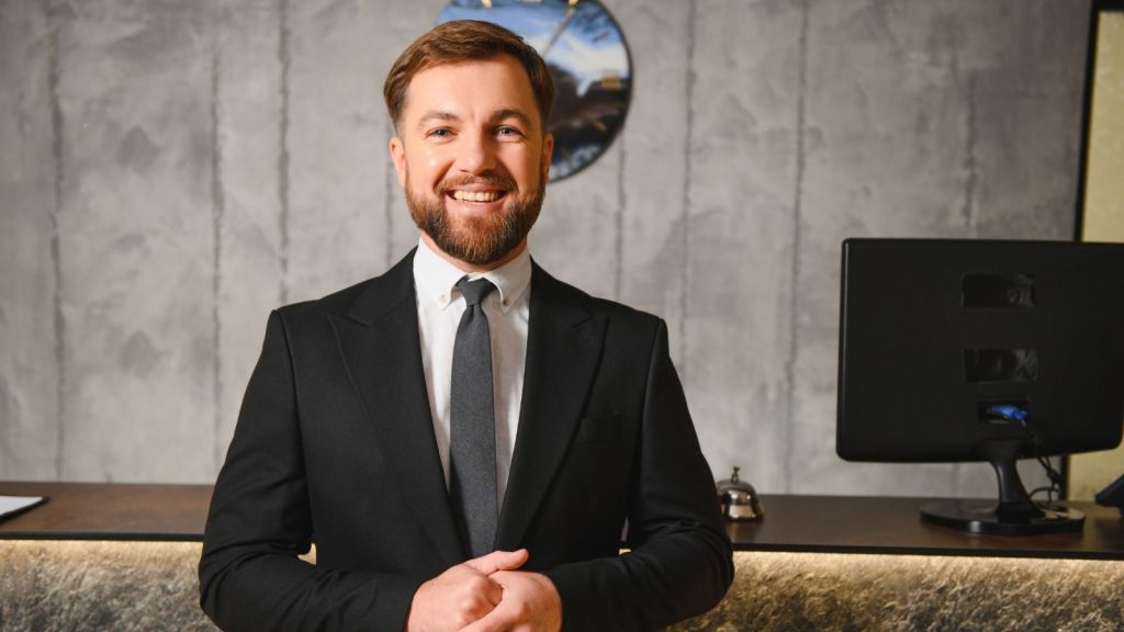 smiling hotel front desk worker