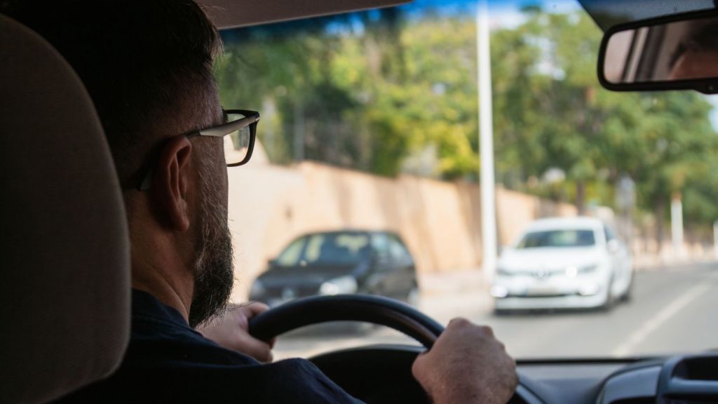 man driving a car