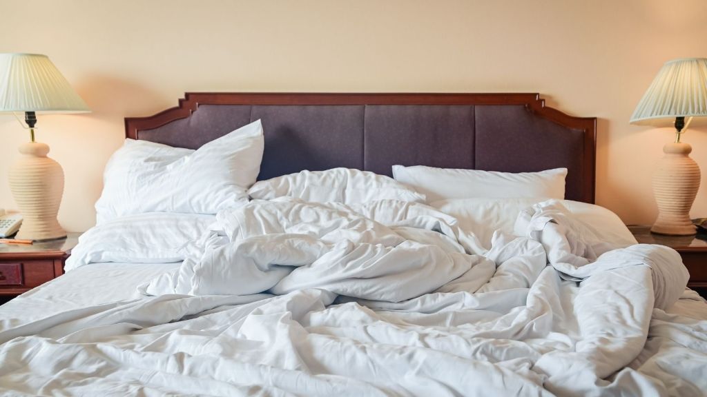 unmade bed in a hotel room