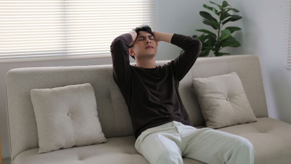 frustrated young man sitting on a couch