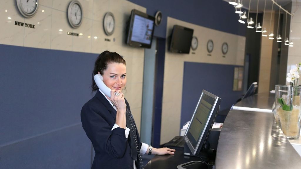 woman working at the front desk of a hotel