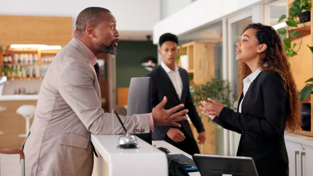 angry man talking to hostess