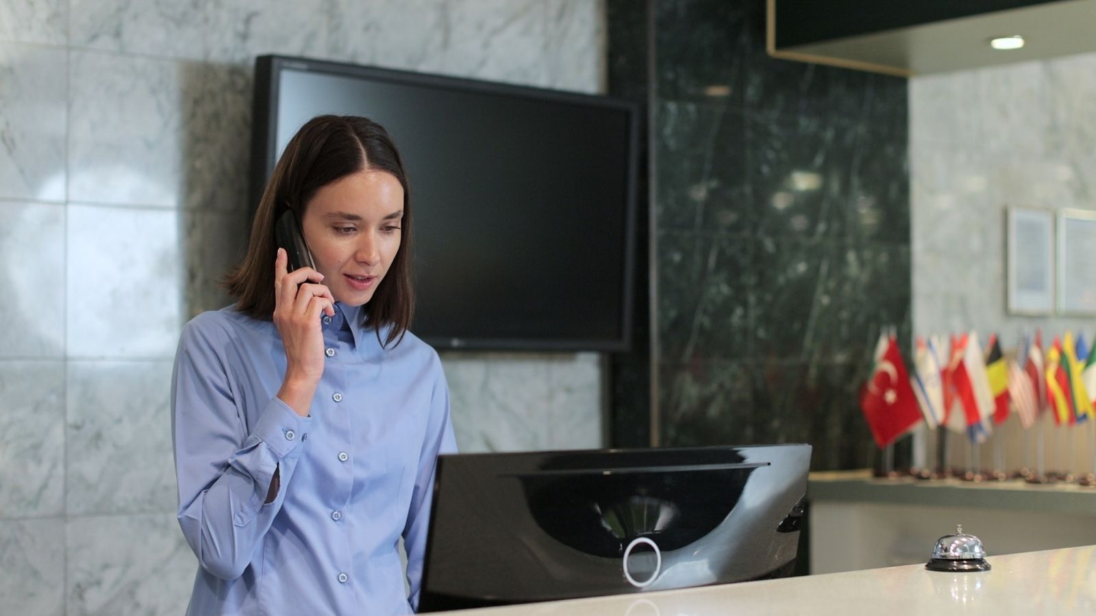 Her Mom Has Held a Hotel Reservation Every Saturday for Years—But Hasnt Stepped Foot in the Room in a Decade hotel front desk worker talking on the phone
