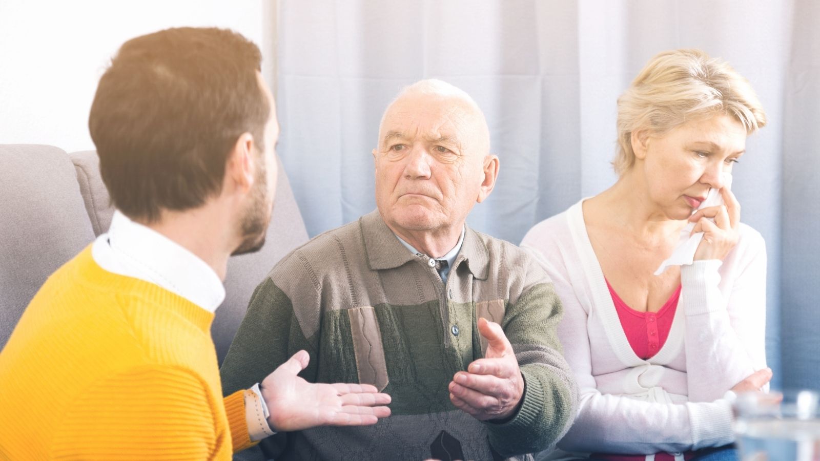 They Set Their Sights on an Upscale Assisted Living Neighborhood. The Only Way They Can Afford It Is if Their Only Child Foots Part of the Bill man talking to his elderly parents about something important