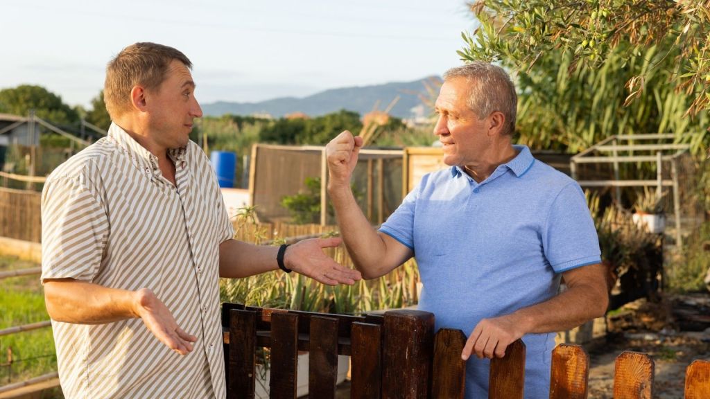 two older men arguing outside