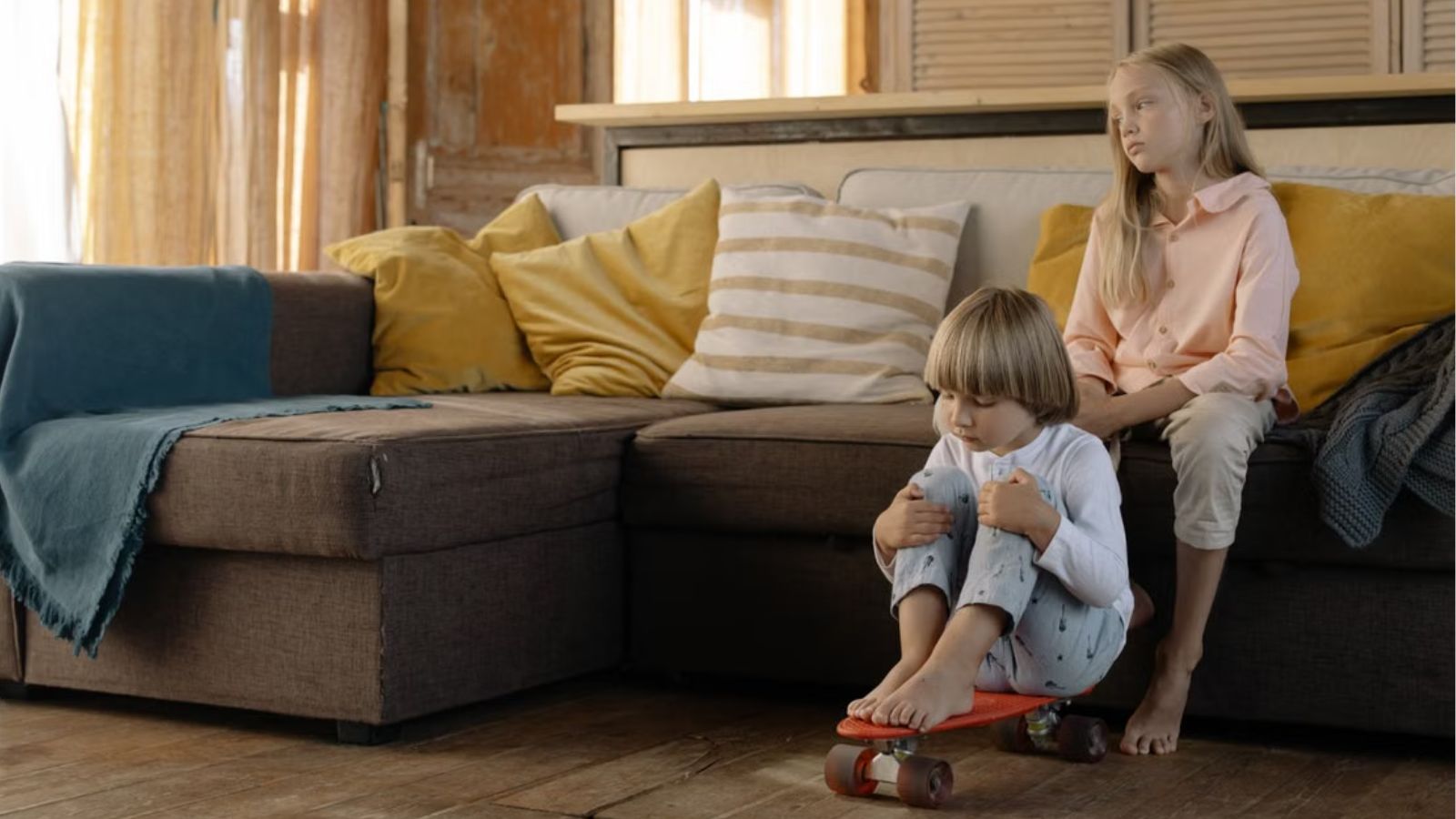 A young boy and a young girl playing inside the house