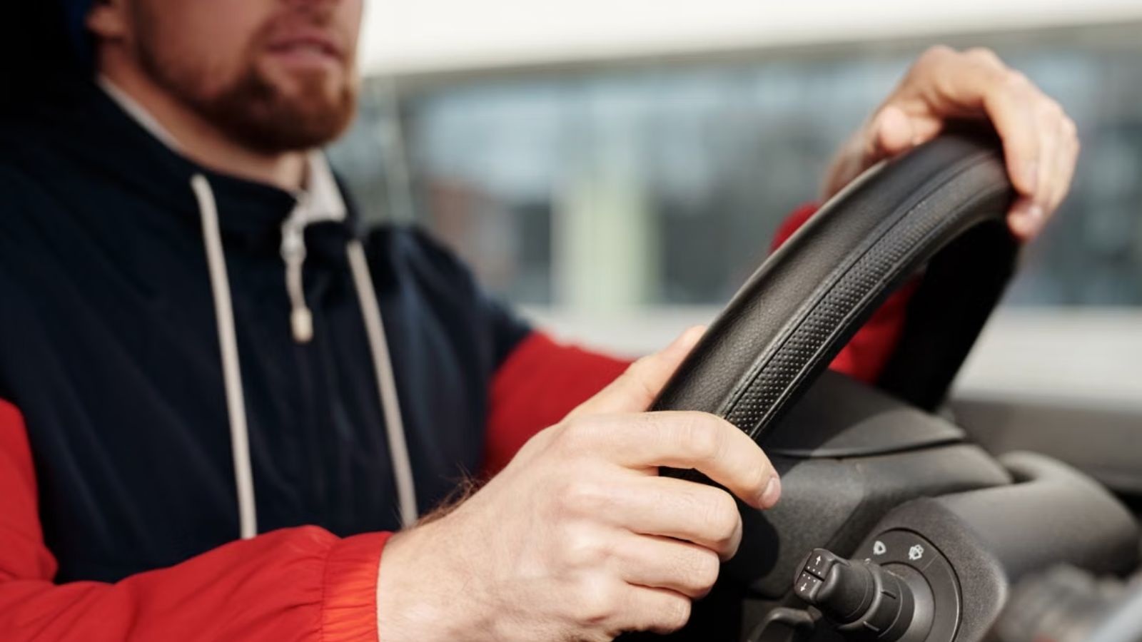 Sober Driver Refuses to Give Everyone a Ride Home After Friends Assume He’ll Do It Man in hoodie driving a car