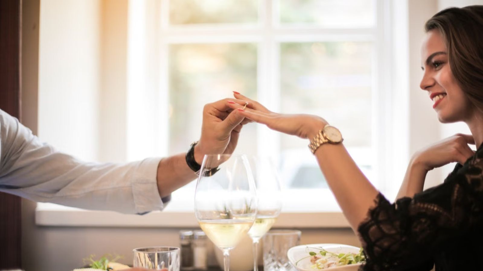 Her Daughter’s Boyfriend Asked Her to Stay Away From His Proposal—Now She Doesn’t Know Whether to Go Man proposing and putting a ring on a woman's finger in a restaurant