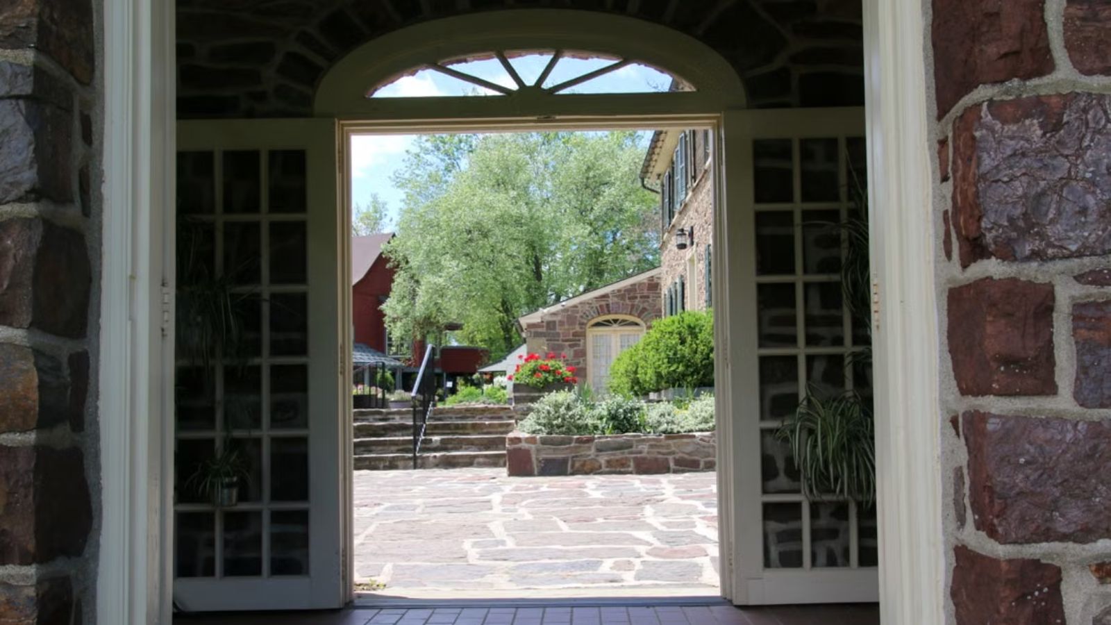 A widely open set of doors showing a lovely view outdoors
