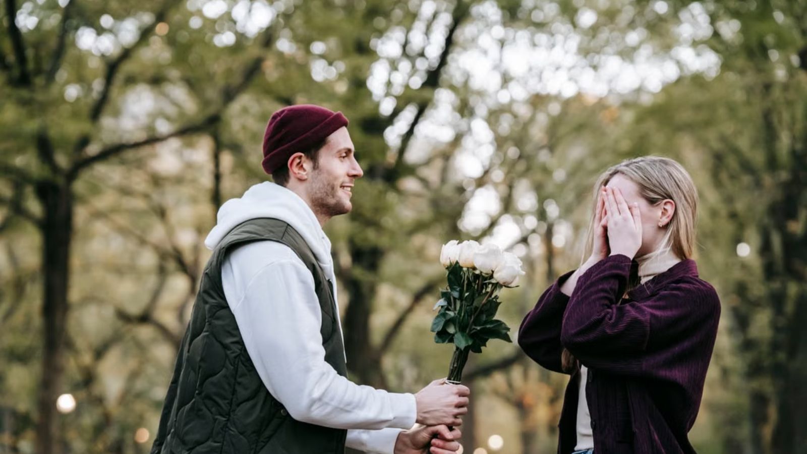 She Gave Her Best Friend’s Boyfriend Some Relationship Advice—Then Both Turned on Her Man handing flowers to a woman who is covering her face with her hands