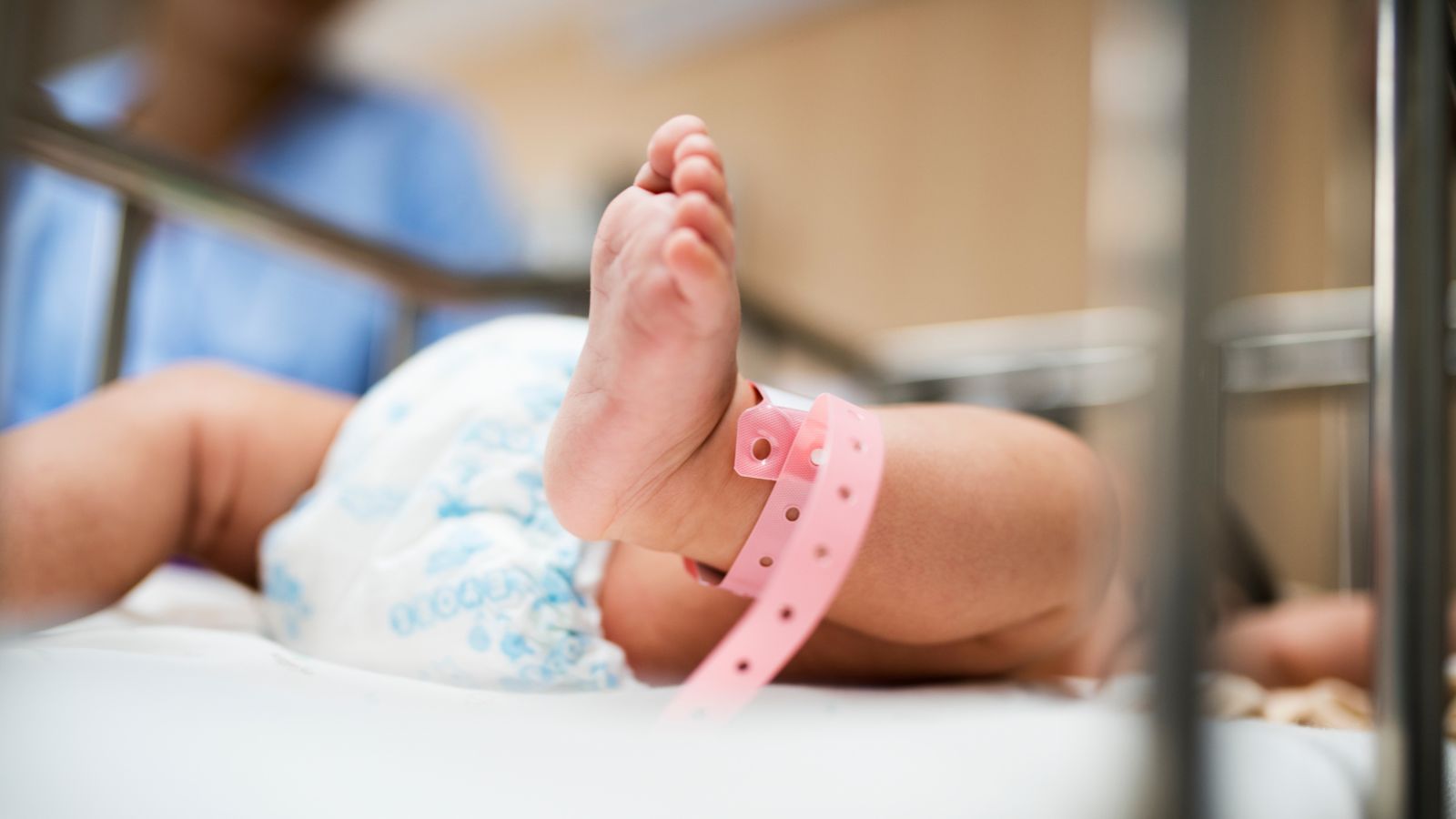 Baby with a hospital bracelet staying the the NICU