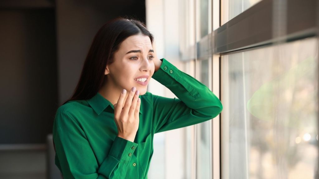 worried woman looking out the window