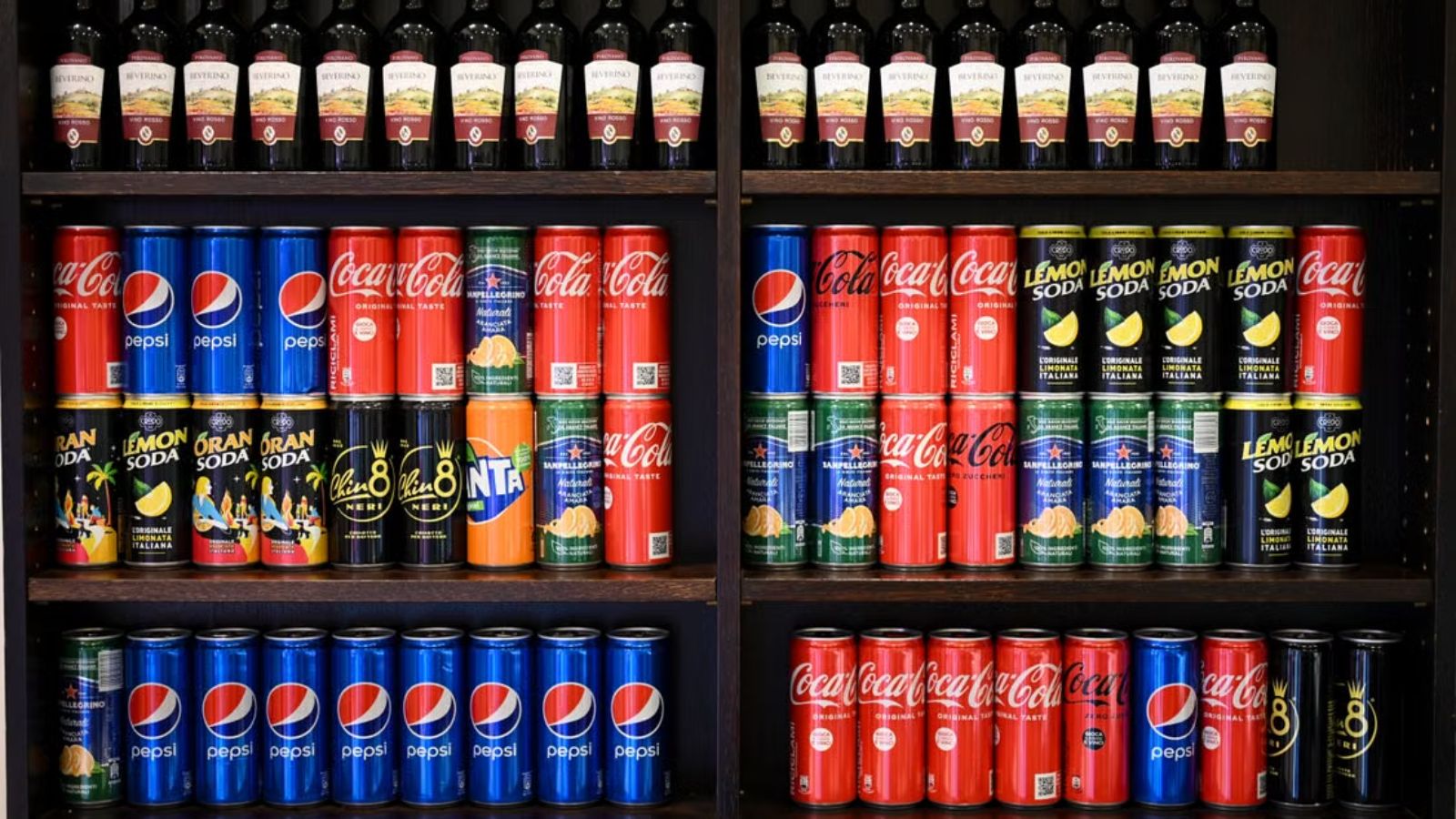 He’s Tired of Seeing the Same Corporations Everywhere—From His Job to the Products He Buys Grocery shelves with different brands of soda cans and drinks
