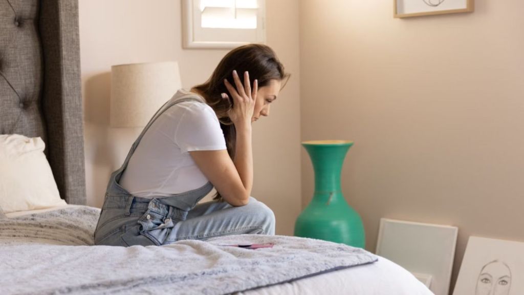 Woman covering her ears with her hands and feeling anxious