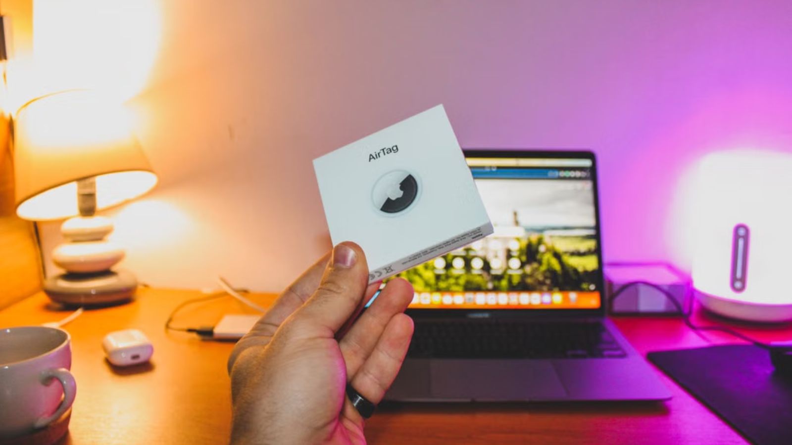 Her Boss Handed Her a GPS Tracker for Emergency Safety—Now She’s Fighting Back Against 24/7 Surveillance Person holding an Apple AirTag box in front of their work station