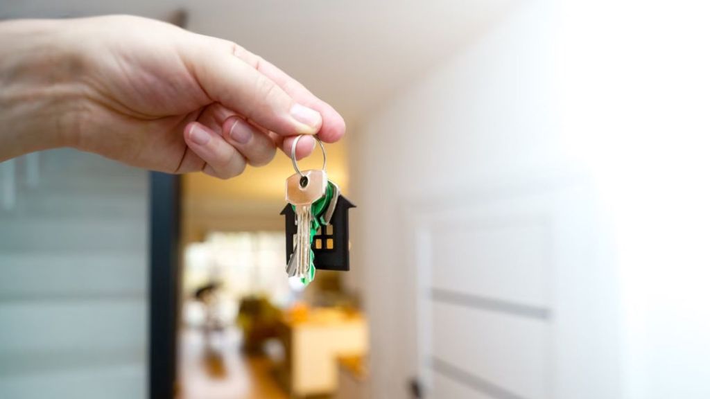 Person holding a key to a new house