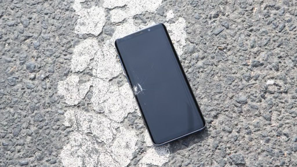 Phone on the ground with a broken screen