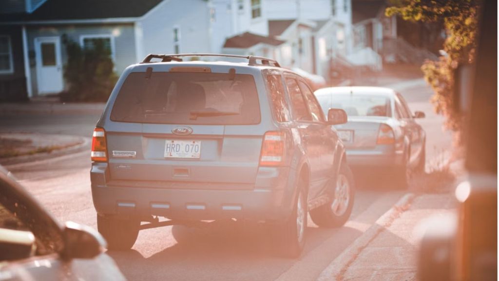 blue SUV parked along a quiet residential street during sunset, capturing a serene urban moment