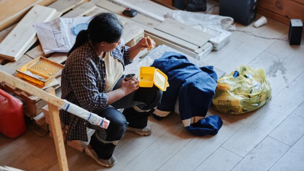 Woman staying in a messy basement and eating some food