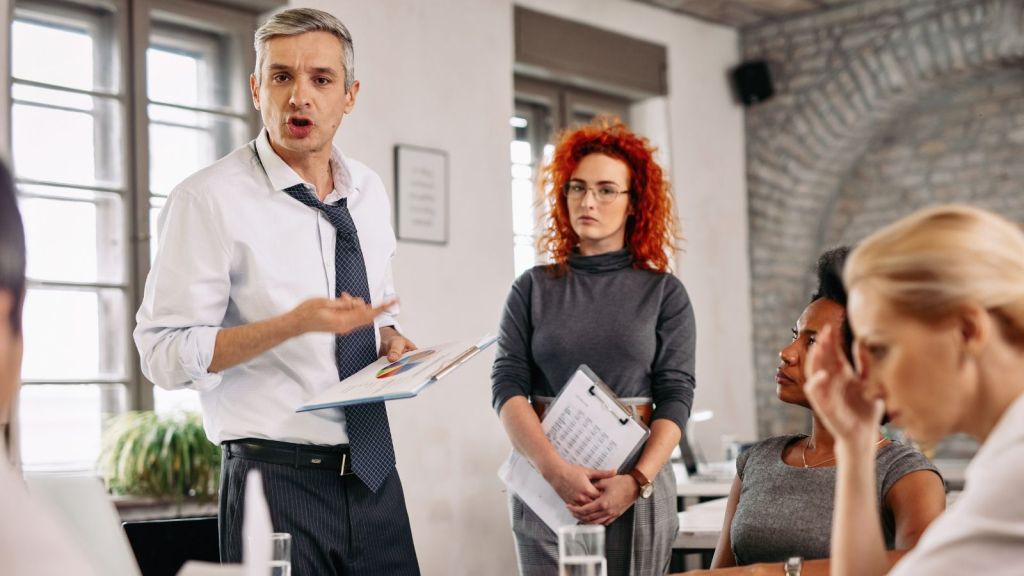 Boss scolding the employees in the office