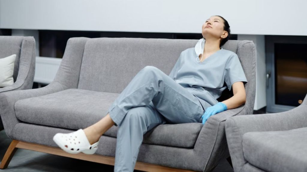 Healthcare employee feeling tired and resting on a couch