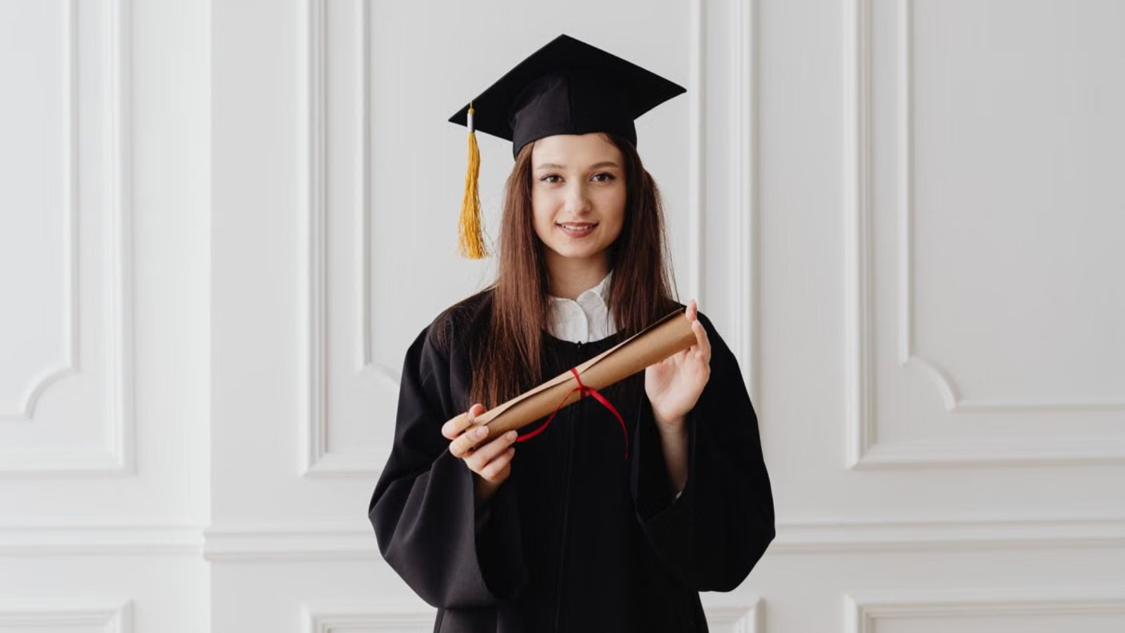 She Was the First in Her Family to Graduate College—but Her Father Dismissed Her Degree and Ruined Her Big Day Woman wearing a graduation gown and cap and holding her diploma