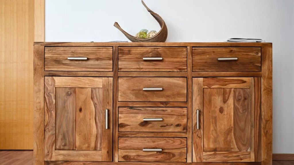 A big wooden cabinet with handles and drawers