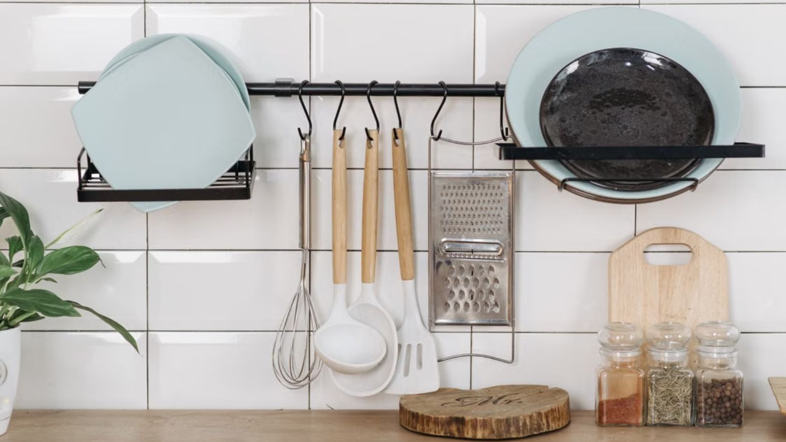 His Landlord Threatened to Evict Him—So He Stopped Providing Everything His Roommates Relied On Kitchen utensils, dishware, and herbs aesthitically placed on a tiled counter