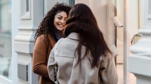 Two women having a conversation outdoors