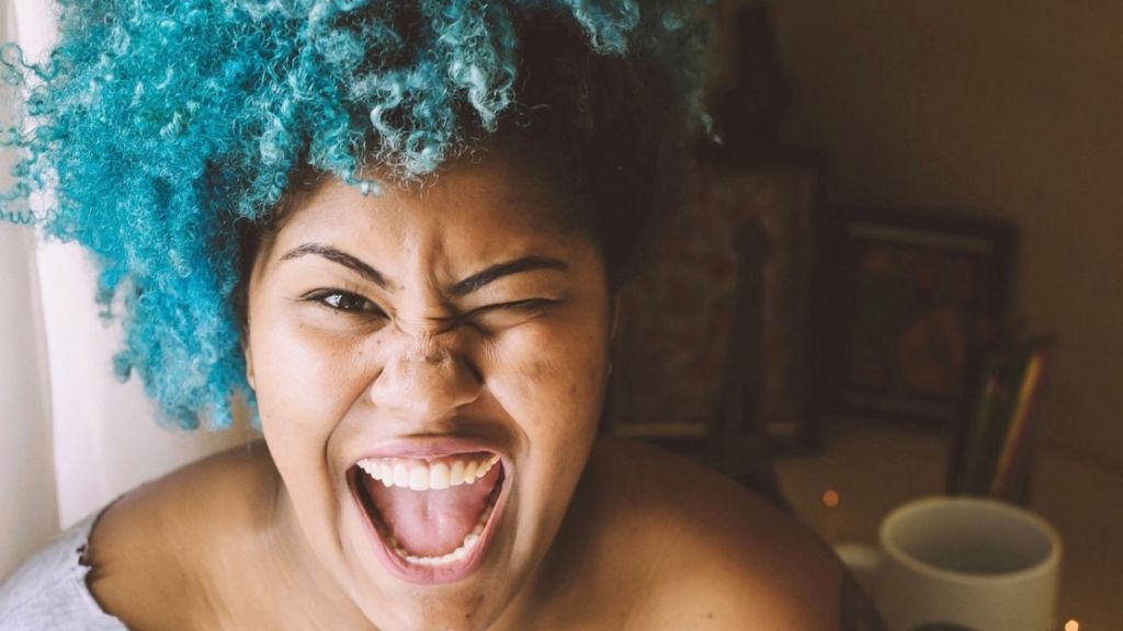 woman with curly teal hair